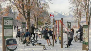 A multi-generational Canadian family engaging with outdoor gym equipment at a municipal recreational facility.