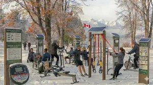 Top-down view of outdoor gym equipment installed with safety-compliant rubber surfacing in a Canadian playground.