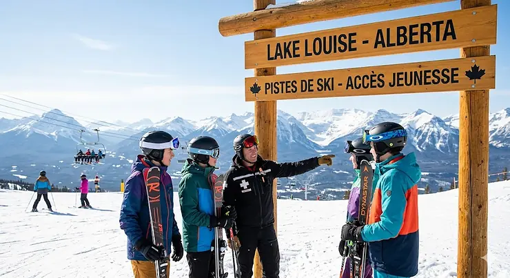 Group of young skiers enjoying a top youth ski package at a snowy Canadian resort.
