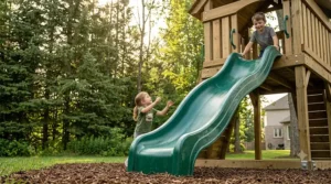 UV-stabilized plastic slide attached to a sturdy pressure-treated wood play set.