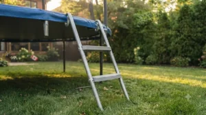 Sturdy metal access ladder paired with a backyard trampoline with safety net for easy entry.