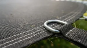 Macro view of heavy-duty, UV-resistant polypropylene fabric used in a durable replacement trampoline mat and springs system.