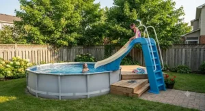 A compact standalone slide placed beside a small above-ground pool in a compact backyard.