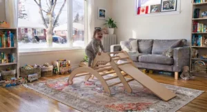 A Montessori-inspired wooden climbing frame set up for toddler playtime in a Canadian playroom.