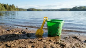 A family enjoying a sunny afternoon at a provincial park beach with their beach toy set for kids.